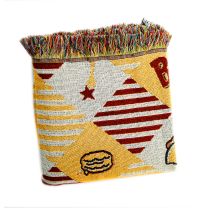 Folded view of the Bojangles woven blanket with fringe across the top 
