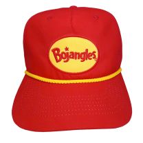 Trucker style hat in red with a yellow rope at the flat brim. A patch is on the front that is a yellow oval with the Bojangles logo embroidered in the middle in red. 